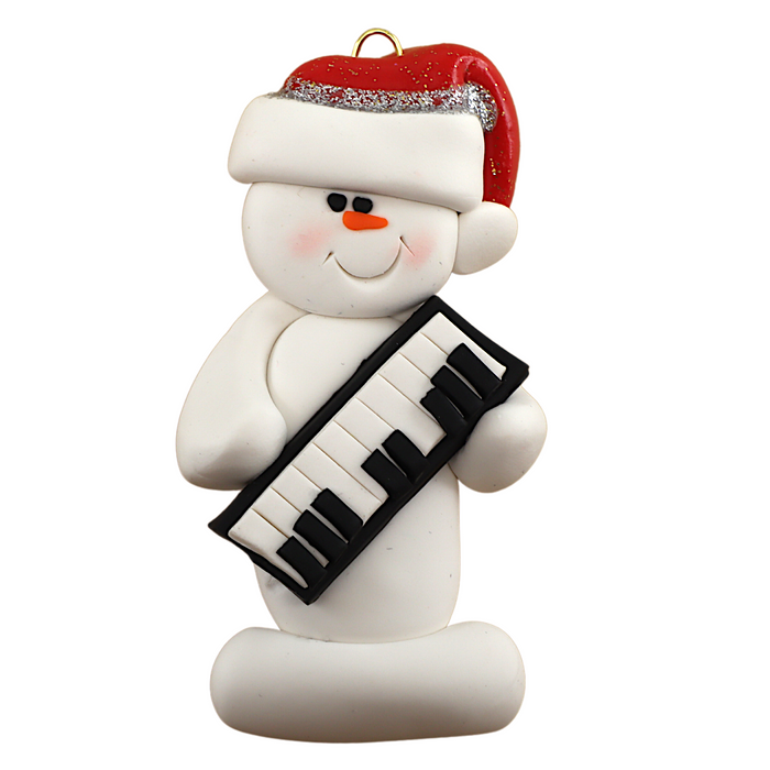 Ornament of white snowman in red hat holding a piano keyboard.