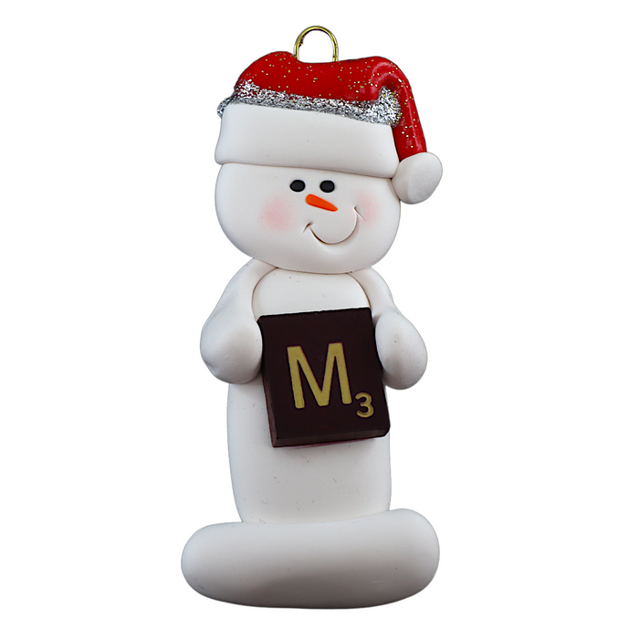 Ornament of white snowman in red hat holding a scrabble tile.