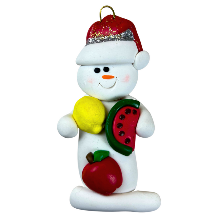 Ornament of white snowman in red hat holding various fruits.