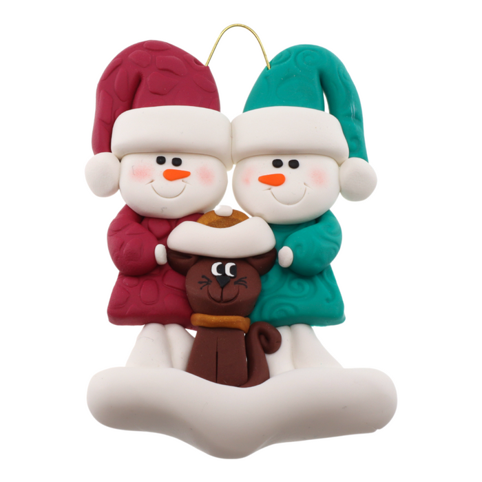 Ornament of snowman couple in red and green shirts and hats with a brown cat in Christmas hat.