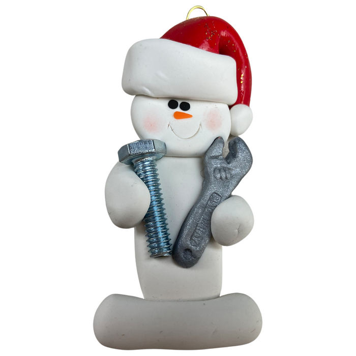 Ornament of white snowman in red hat holding a wrench and a screw.