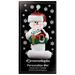 Ornament of white snowman in red hat holding a sign with a house saying “sold”, on display backing card.