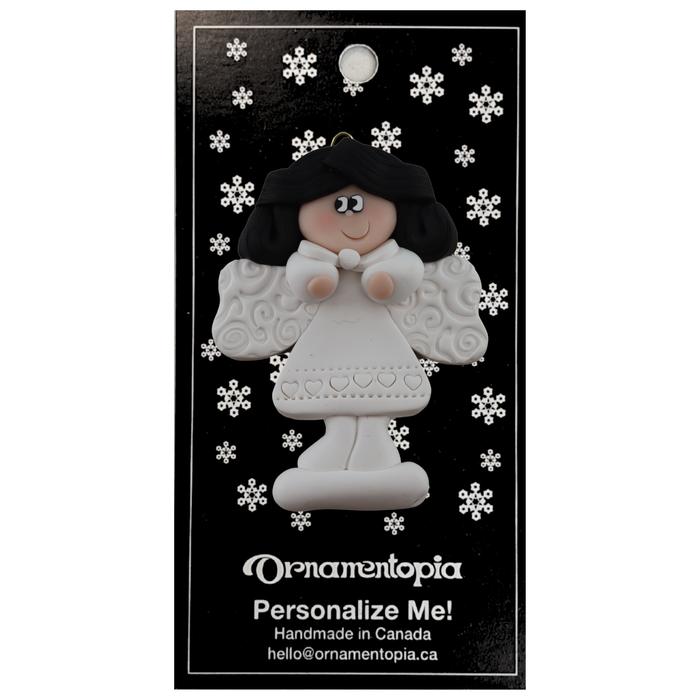 Angel wearing white with black hair ornament, on display backing card.