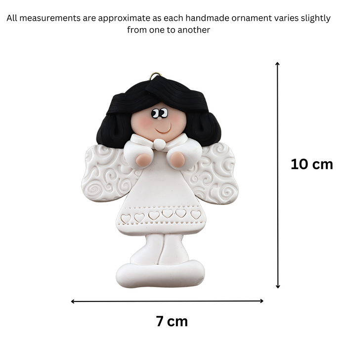 Angel wearing white with black hair ornament, graphed to show size (7x10cm).