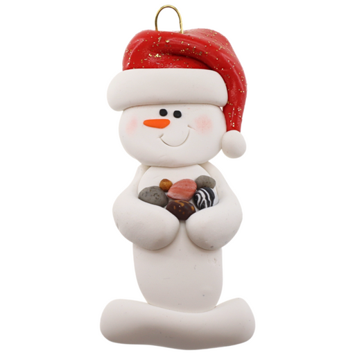 Ornament of white snowman in red hat holding several small rocks.