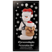 Ornament of white snowman in red hat holding a tan dog and stethoscope, on display backing card.