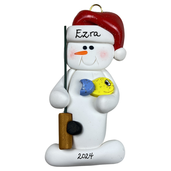 Ornament of white snowman in red hat holding a fishing pole and colourful fish, personalized with name.