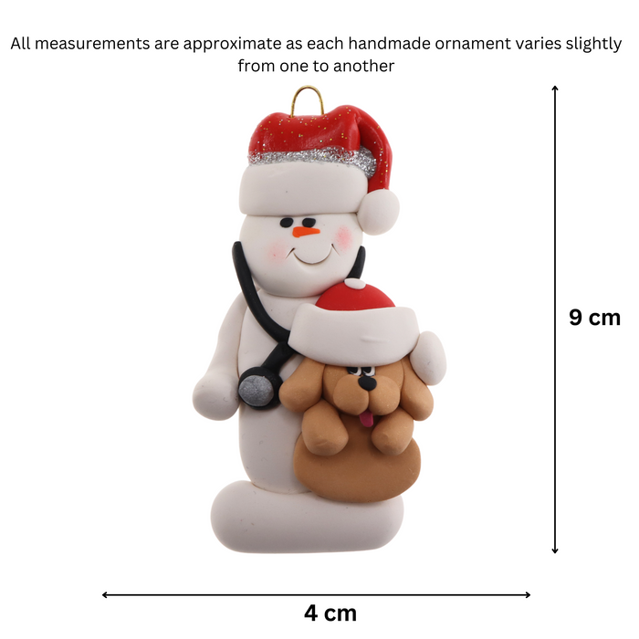 Ornament of white snowman in red hat holding a tan dog and stethoscope, graphed to show size (4x9cm).